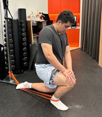 PHysio TJ doing banded ankle mobilization into dorsiflexion