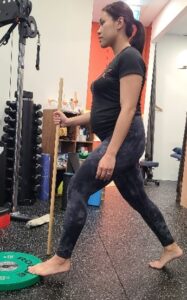 Physio Helen demonstrates elevated heel split squats