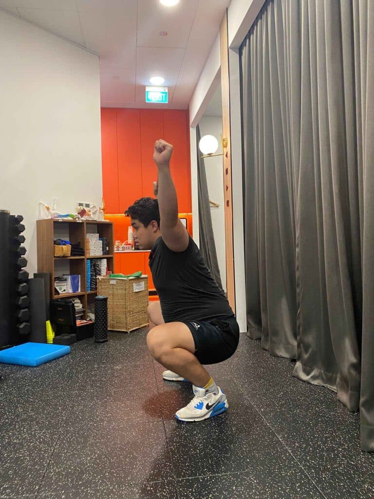 Physio TJ doing Overhead Squat Test